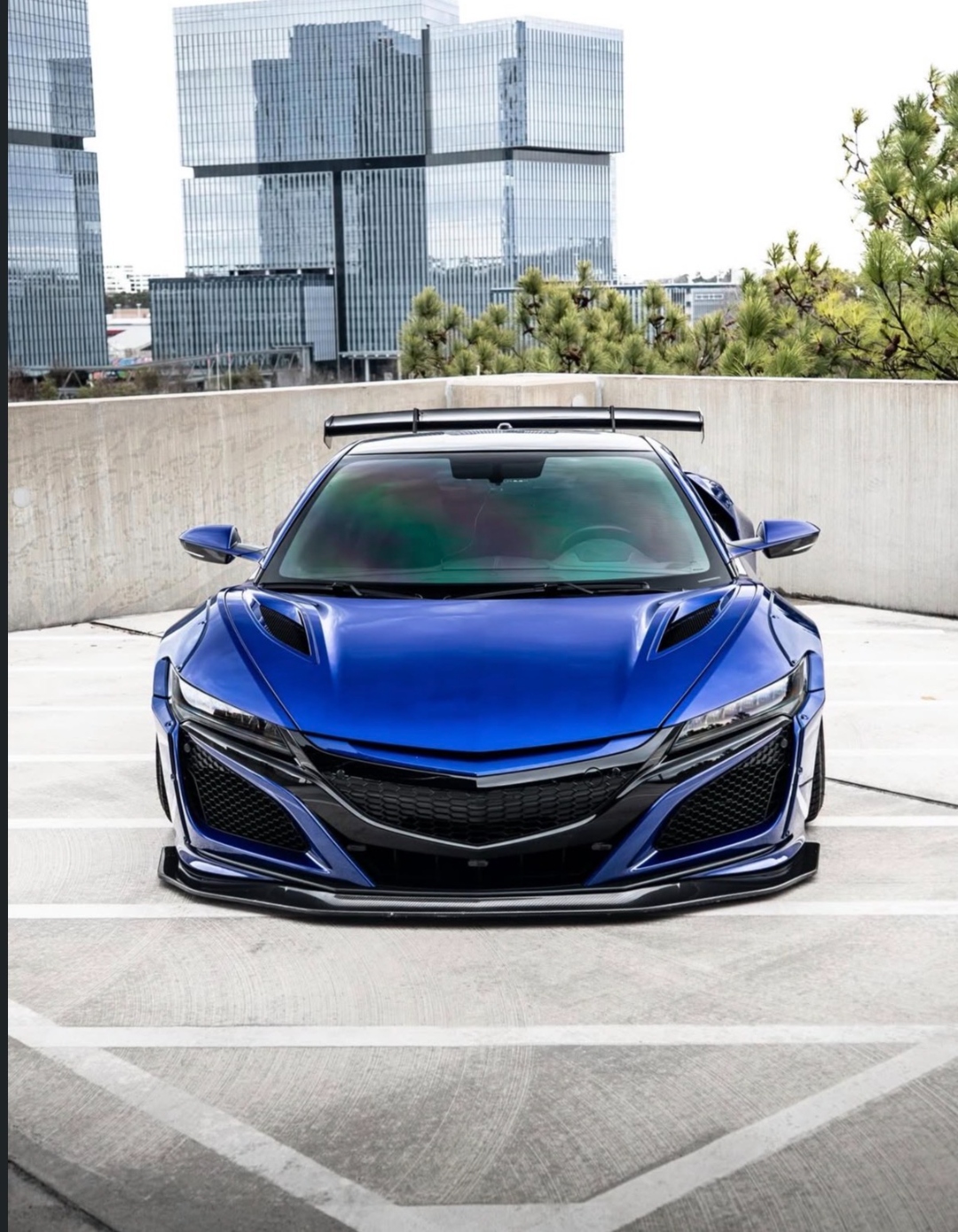 Blue Acura NSX on rooftop with Atlanta skyline