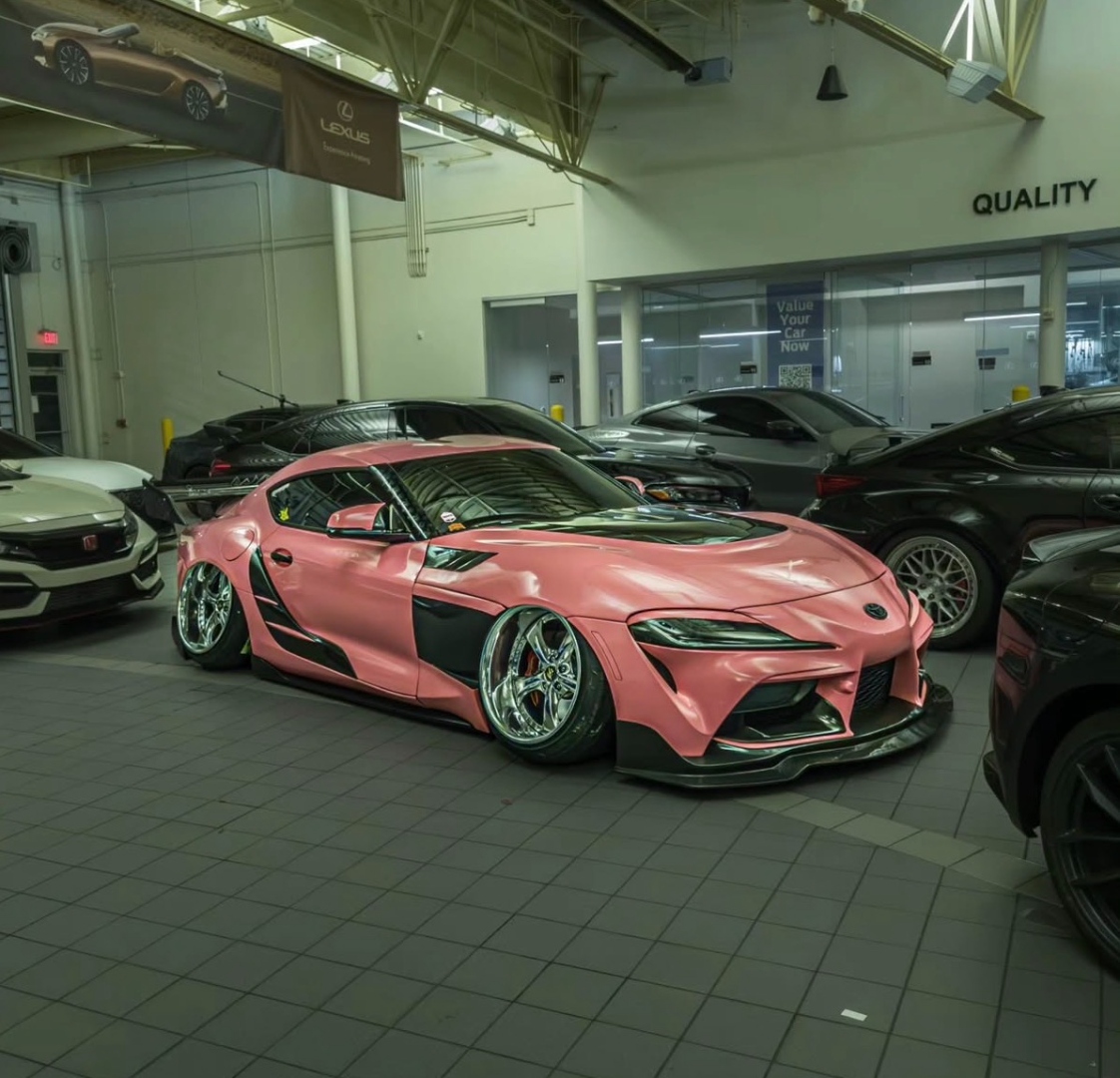 Pink Toyota Supra widebody inside Lexus dealership
