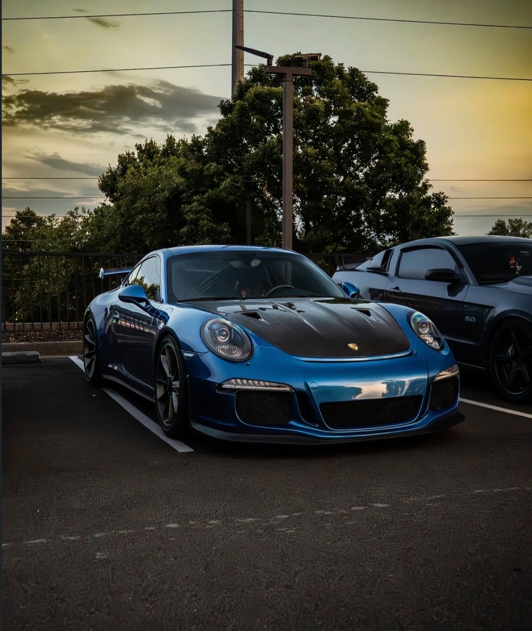 Blue Porsche 911 GT3 at car meet sunset
