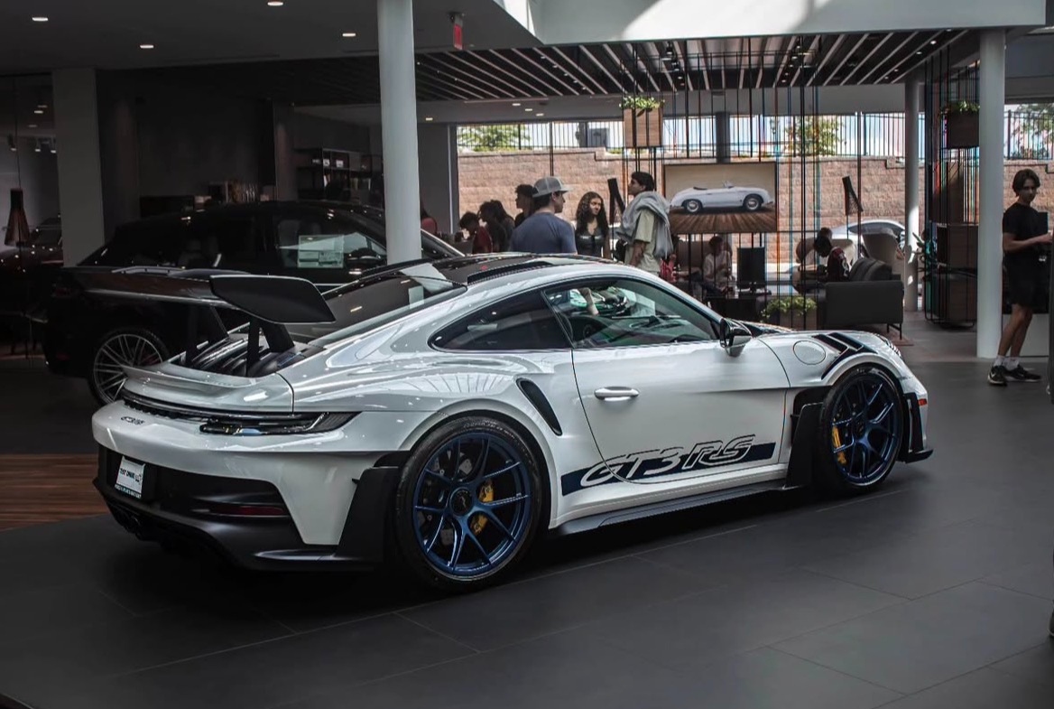 Porsche 911 GT3 RS activation at Porsche dealership with crowd
