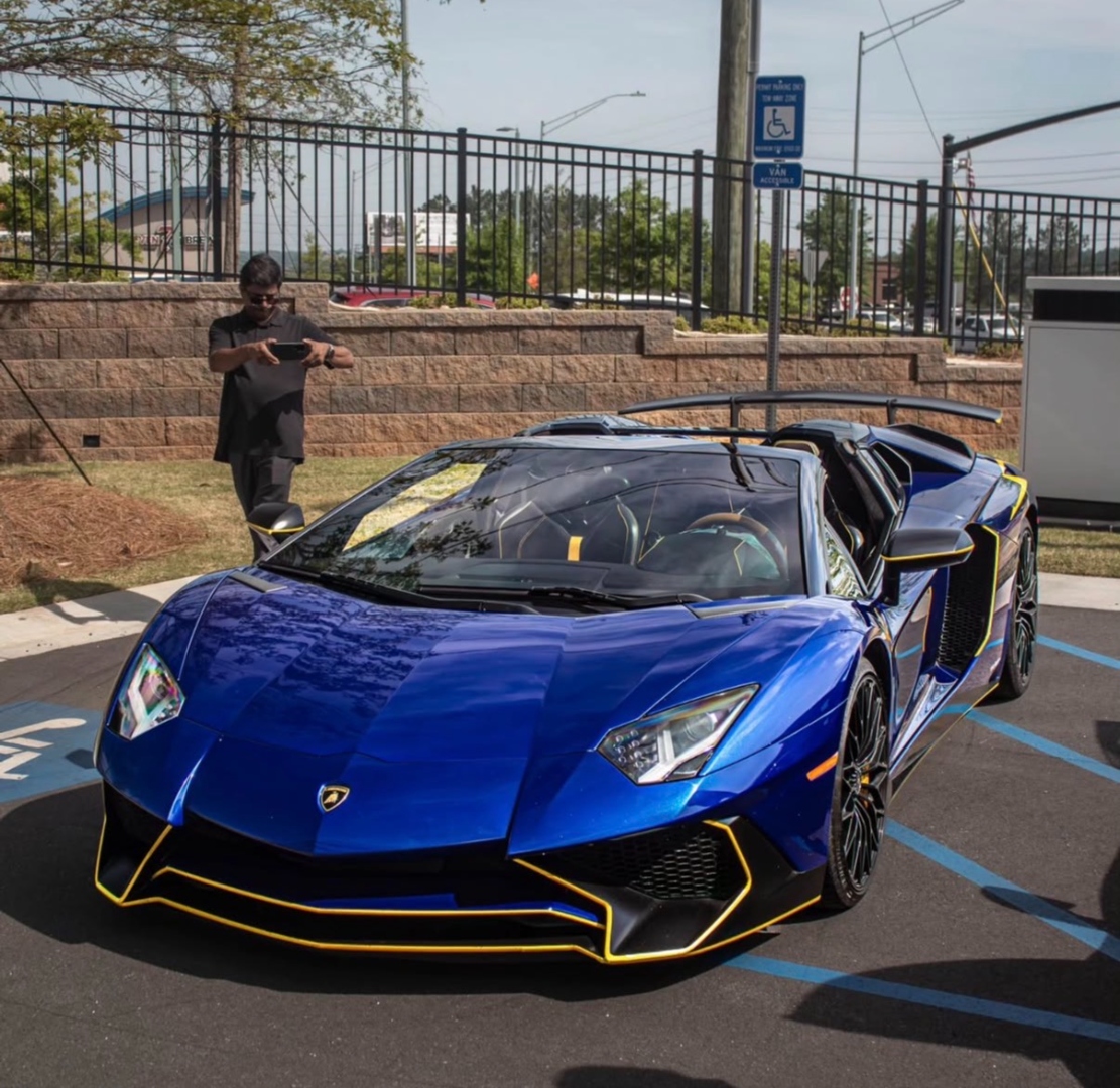 Blue Lamborghini Aventador SV at Fastlane event with community around it