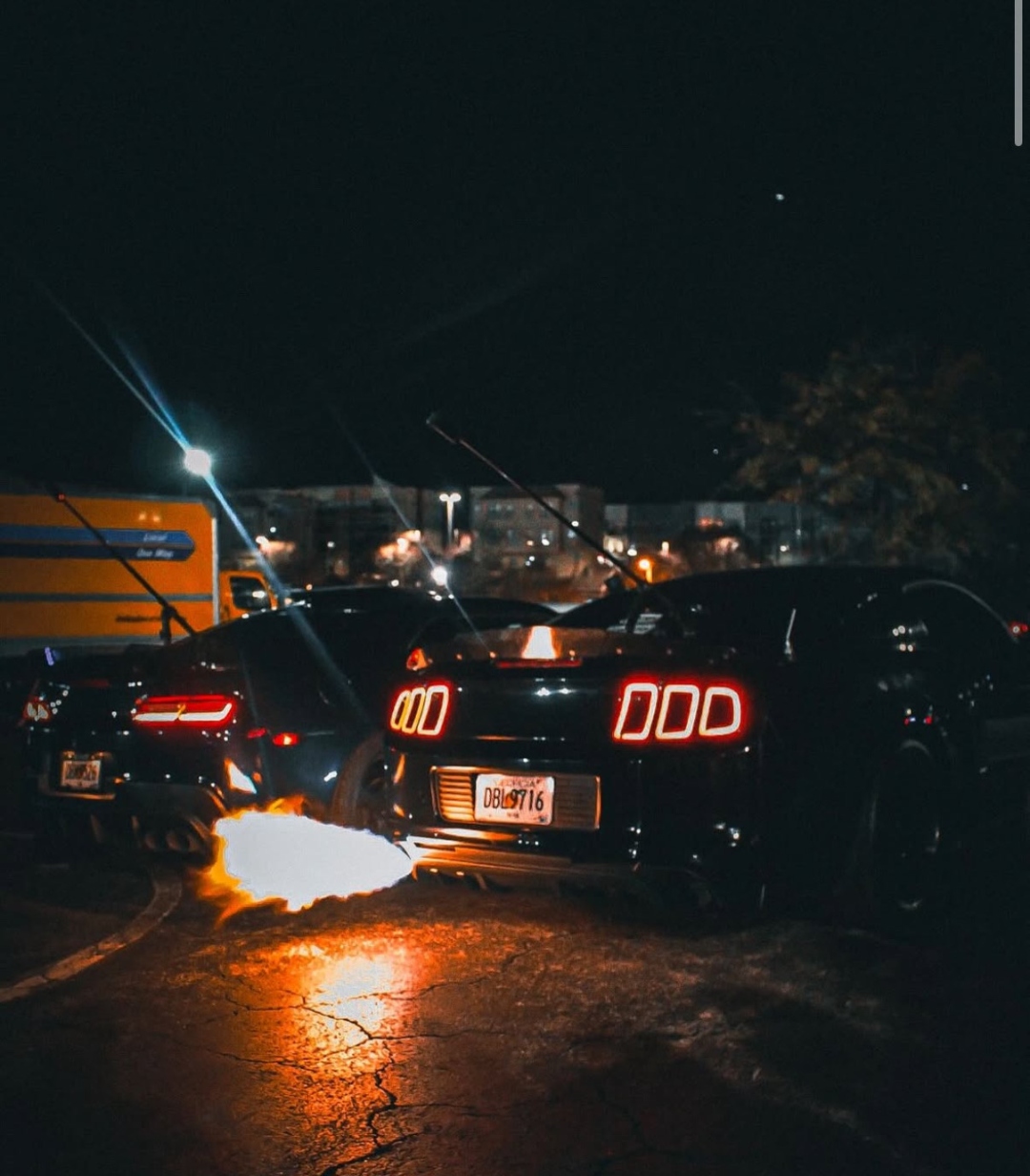 Mustang shooting flames at night car meet